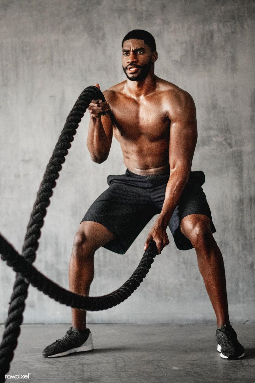 Muscular man working out on the battle ropes in a gym | premium image by rawpixel.com / Tedd… | Male fitness photography, Gym photography, Women fitness photography